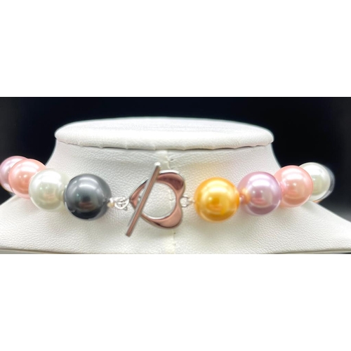 822 - A Vivid Multi-Coloured South Sea Pearl Shell Large Bead Necklace. 12mm beads. 44cm necklace length.