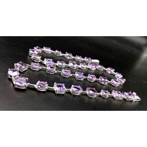 912 - An Amethyst Gemstone Tennis Necklace set in 925 Silver.
46cm length. Square and oval shapes. 32.37g ... 