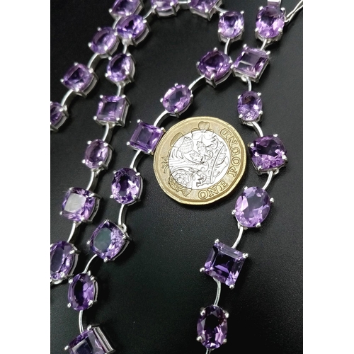 912 - An Amethyst Gemstone Tennis Necklace set in 925 Silver.
46cm length. Square and oval shapes. 32.37g ... 