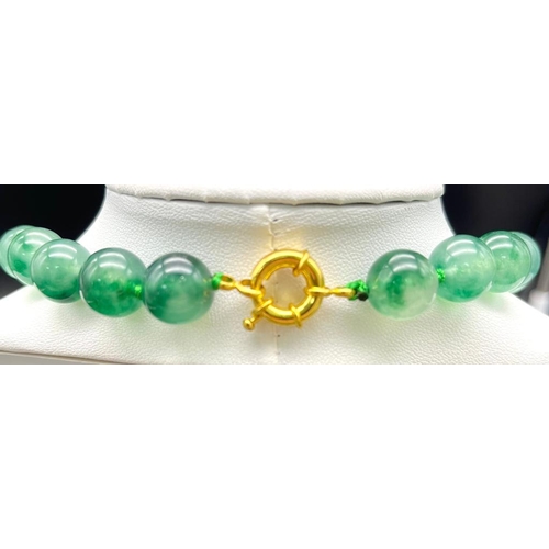 953 - A Green and White Jade Bead Necklace with Hanging Pendant. Gilded accents and clasp. Beads 12mm/14mm... 