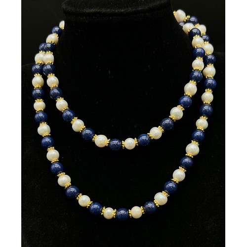 303 - A Lapis Lazuli and Cultured Pearl Matinee Necklace. 8mm beads and pearls. Gilded spacers and clasp. ... 