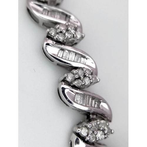 13 - A 14K WHITE GOLD DIAMOND SWIRL BRACELET. A COMBINATION OF BAGUETTE AND ROUND CUT DIAMONDS 2.30CT 15.... 