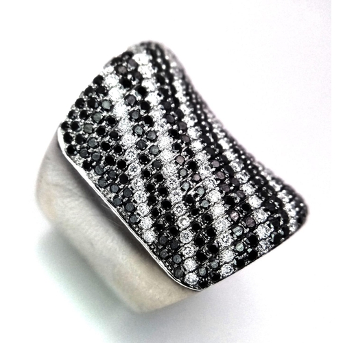 204 - An Incredible Black and White Diamond 18K Gold Dress Ring. This cylindrical masterpiece has over 200... 