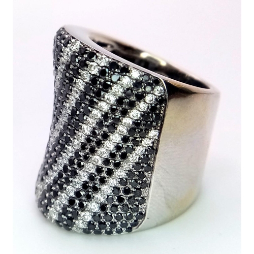 204 - An Incredible Black and White Diamond 18K Gold Dress Ring. This cylindrical masterpiece has over 200... 