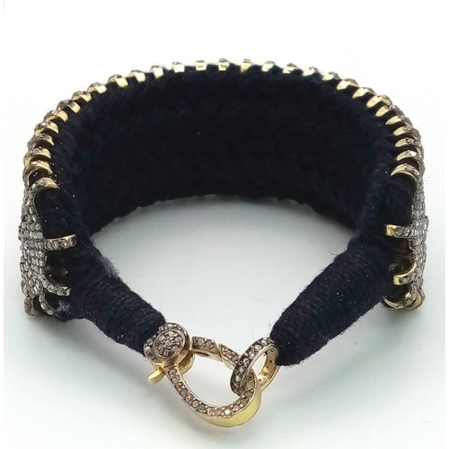 43 - A Brilliantly Unique Handcrafted Designer Diamond Bracelet. A black woven textile bracelet strap ado... 