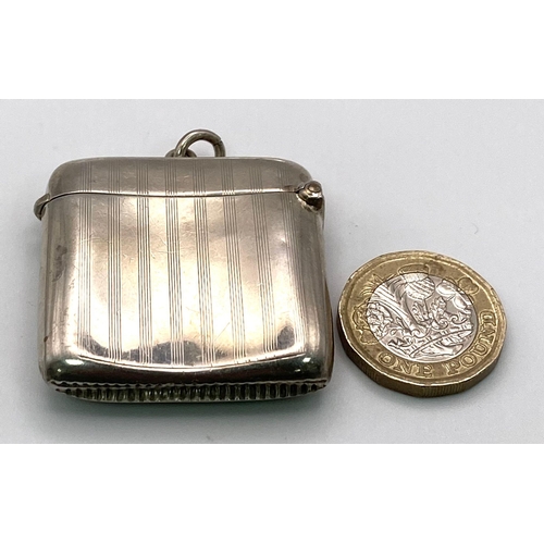 498 - An Antique Sterling Silver Vesta Case. Machine tooled decoration with empty cartouche. Hallmarks for... 