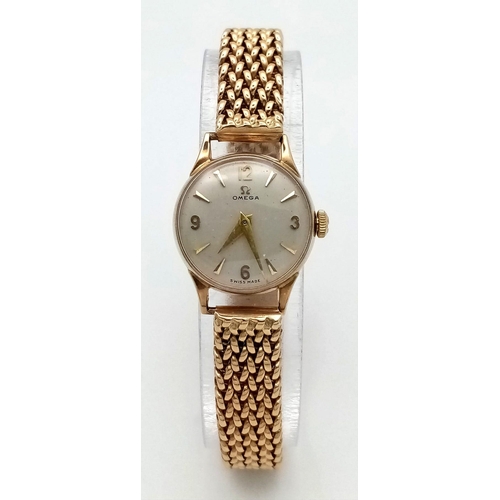 553 - A Vintage 9K Yellow Gold Omega Watch. 9k gold mesh bracelet. 9k gold case - 19mm. White dial. Mechan... 