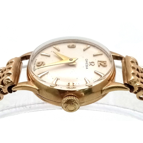 553 - A Vintage 9K Yellow Gold Omega Watch. 9k gold mesh bracelet. 9k gold case - 19mm. White dial. Mechan... 