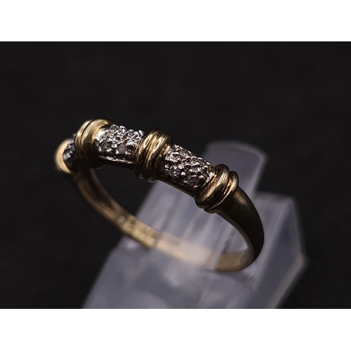 578 - A 9K GOLD AND DIAMOND DESIGNER RING .  1.8gms   size N