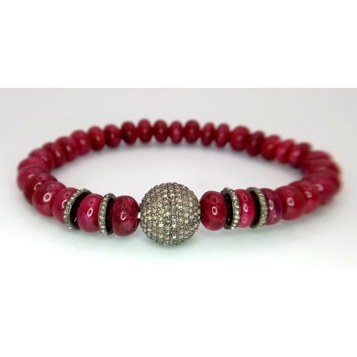 583 - An African Ruby and Diamond Expandable Bracelet. Ruby rondelles and diamond glitterball. Ruby - 105c... 