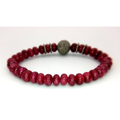 583 - An African Ruby and Diamond Expandable Bracelet. Ruby rondelles and diamond glitterball. Ruby - 105c... 