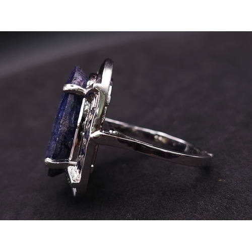 584 - A Blue Sapphire and 925 Silver Ring. Oval cut central sapphire with small sapphire accents. Size R. ... 