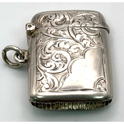 885 - An Antique Sterling Silver Vesta Case. Engraved scroll decoration. Working hinge. Hallmarks for Birm... 