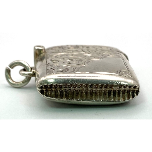 885 - An Antique Sterling Silver Vesta Case. Engraved scroll decoration. Working hinge. Hallmarks for Birm... 