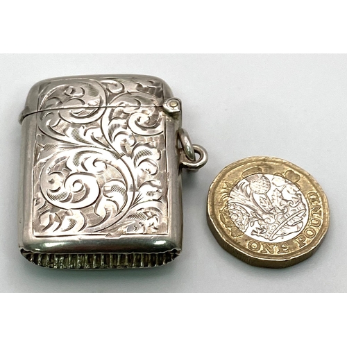 885 - An Antique Sterling Silver Vesta Case. Engraved scroll decoration. Working hinge. Hallmarks for Birm... 