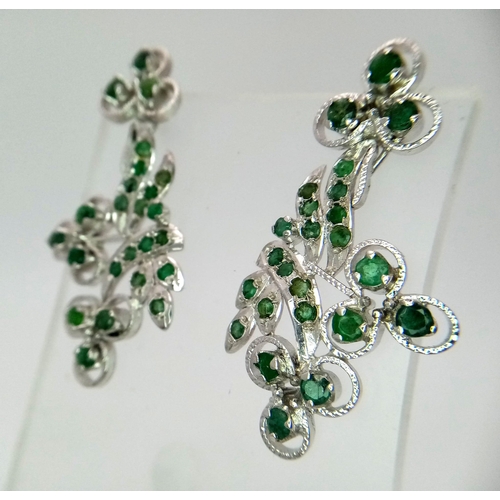 563 - A Pair of Emerald Floral Drop Earrings. Set in 925 sterling silver. Emeralds - 11.50ctw. 11g total w... 