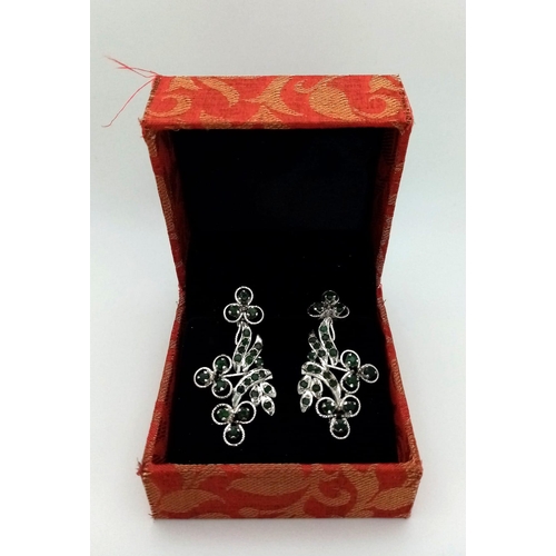 563 - A Pair of Emerald Floral Drop Earrings. Set in 925 sterling silver. Emeralds - 11.50ctw. 11g total w... 