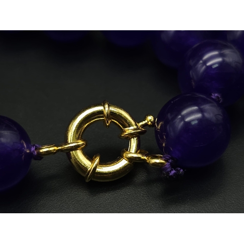 576 - A Purple Jade with Hanging Purple Jade Pendant. Gilded accents and clasp. 44cm necklace length. 12mm... 