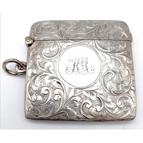 640 - An Antique Sterling Silver Vesta Case. Scrolled engraving with monogram cartouche. Hinge in working ... 