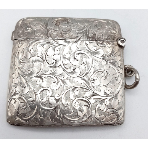 640 - An Antique Sterling Silver Vesta Case. Scrolled engraving with monogram cartouche. Hinge in working ... 