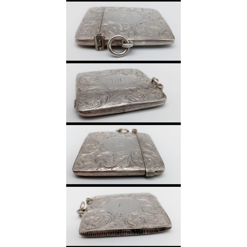 640 - An Antique Sterling Silver Vesta Case. Scrolled engraving with monogram cartouche. Hinge in working ... 