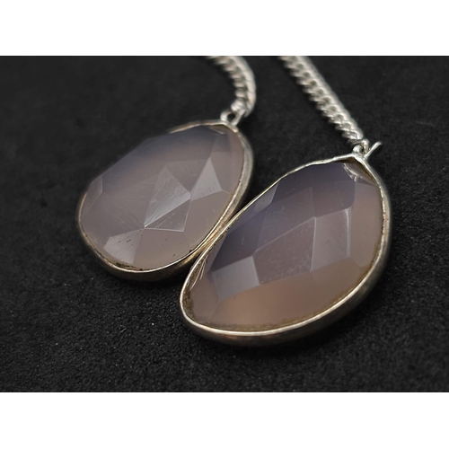 920 - A Pair of Rose Quartz 925 Silver Drop Earrings. Rose quartz - 50ctw. Drop 7cm. 13.10g total weight. ... 