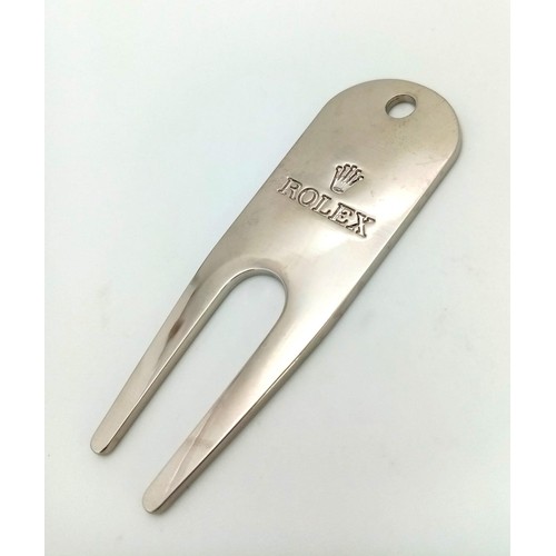 729 - A Rolex Golf Divot Tool. Repair that putting green divot in style. Engraved white metal. As new.