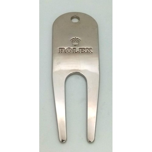 729 - A Rolex Golf Divot Tool. Repair that putting green divot in style. Engraved white metal. As new.