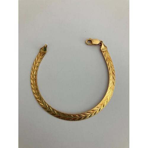 28 - 18 carat GOLD BRACELET. Attractive Flat Design having Chased Chevron Pattern.  8.9 grams. 19cm.