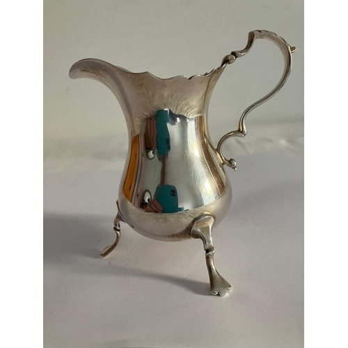 91 - Stunning vintage SILVER CREAMER JUG Having fluted serpentine top with scroll handle and standing on ... 