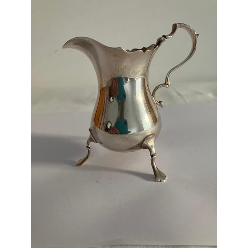 91 - Stunning vintage SILVER CREAMER JUG Having fluted serpentine top with scroll handle and standing on ... 