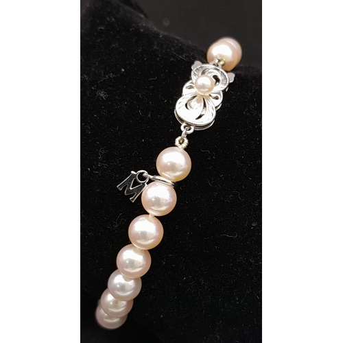 577 - An Elaborate Japanese Mikimoto Akoya Pearl Jewellery Set. A necklace, bracelet and pair of stud earr... 