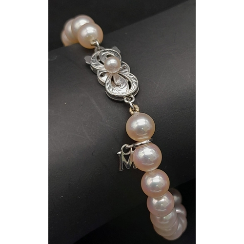 577 - An Elaborate Japanese Mikimoto Akoya Pearl Jewellery Set. A necklace, bracelet and pair of stud earr... 