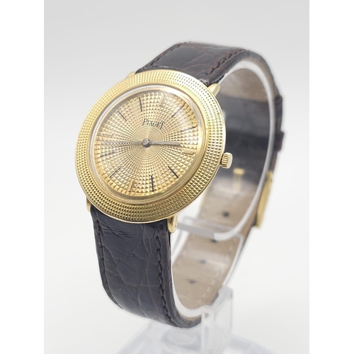 22 - A Vintage 18K Gold Piaget Gents Watch with Hypnotic Dial. Brown crocodile strap. 18k gold case - 30m... 