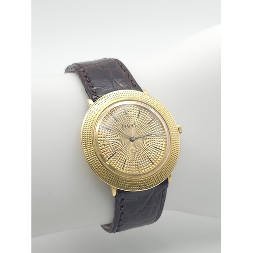 22 - A Vintage 18K Gold Piaget Gents Watch with Hypnotic Dial. Brown crocodile strap. 18k gold case - 30m... 