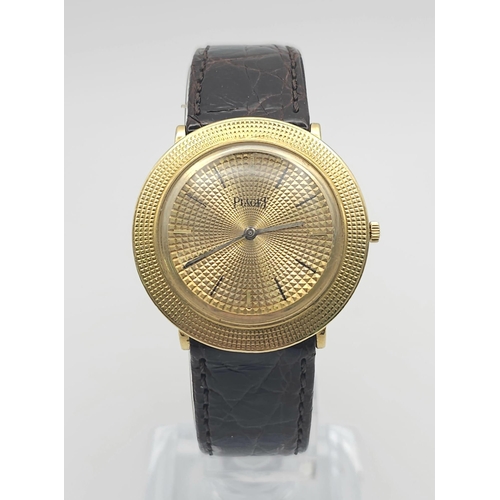 22 - A Vintage 18K Gold Piaget Gents Watch with Hypnotic Dial. Brown crocodile strap. 18k gold case - 30m... 