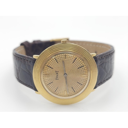 22 - A Vintage 18K Gold Piaget Gents Watch with Hypnotic Dial. Brown crocodile strap. 18k gold case - 30m... 