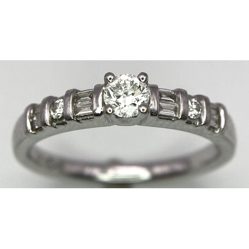 713 - 18kt White Gold, Diamond Ring.
Centre Stone, 0.30ct Round Cut Diamond, is accented by shoulder flank... 