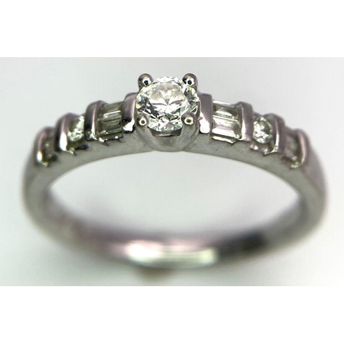 713 - 18kt White Gold, Diamond Ring.
Centre Stone, 0.30ct Round Cut Diamond, is accented by shoulder flank... 