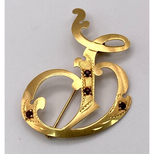 351 - A Vintage 18K Yellow Gold and Garnet Monogram Shaped Brooch. 4.5cm. 3.3g total weight.