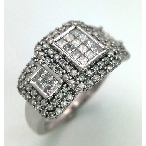 739 - An Art Deco Style 18K White Gold and Diamond Ring. A belt-buckle design of round and princess cut di... 