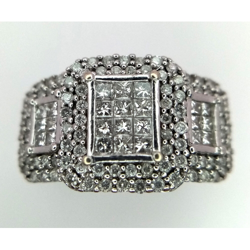 739 - An Art Deco Style 18K White Gold and Diamond Ring. A belt-buckle design of round and princess cut di... 