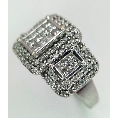 739 - An Art Deco Style 18K White Gold and Diamond Ring. A belt-buckle design of round and princess cut di... 