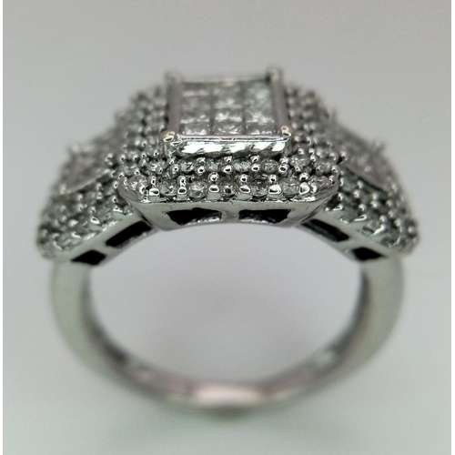 739 - An Art Deco Style 18K White Gold and Diamond Ring. A belt-buckle design of round and princess cut di... 