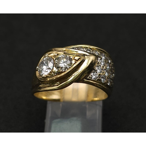 933 - An 18kt Yellow Gold Ring with a duo of Round Cut Diamonds on one side, offset by a pavement of diamo... 