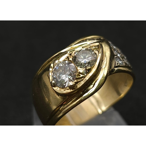 933 - An 18kt Yellow Gold Ring with a duo of Round Cut Diamonds on one side, offset by a pavement of diamo... 