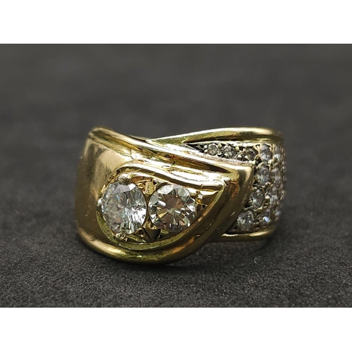 933 - An 18kt Yellow Gold Ring with a duo of Round Cut Diamonds on one side, offset by a pavement of diamo... 