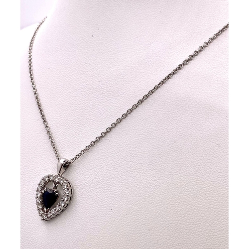 519 - A VERY PRETTY SAPPHIRE AND DIAMOND PENDANT ON A 9K WHITE GOLD 45cms CHAIN .   6.4gms    13075