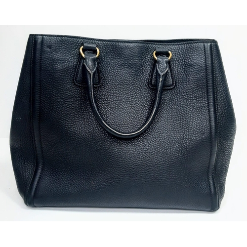 506 - Black PRADA Vitello Daino Handbag.
Luxurious leather, double handle open-top with quality gold tone ... 