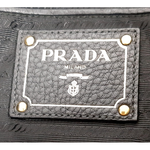 506 - Black PRADA Vitello Daino Handbag.
Luxurious leather, double handle open-top with quality gold tone ... 